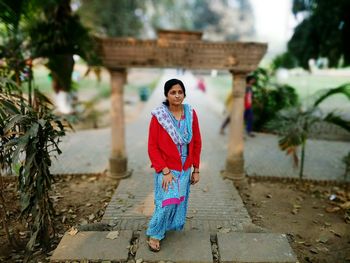 Portrait of young woman standing outdoors