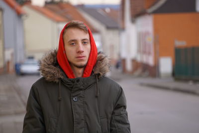 Portrait of man standing on street in city