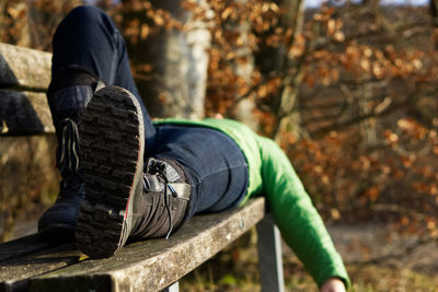 Low section of man sitting on bench