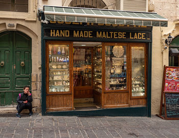 Man sitting at entrance of building