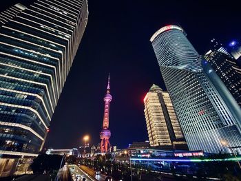 Illuminated modern buildings in city at night