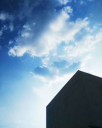 Low angle view of building against cloudy sky