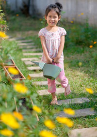 Full length of smiling girl on grass