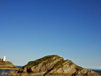 Scenic view of mountains against clear blue sky