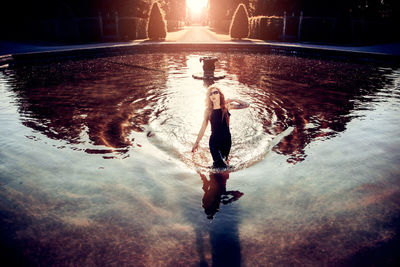 High angle view of fashion model standing in pond