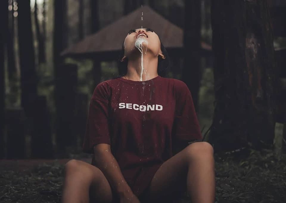 FULL LENGTH OF WOMAN SITTING ON TEXT AGAINST WALL