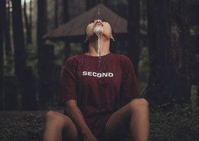 Full length of woman sitting outdoors