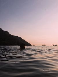 Scenic view of sea against clear sky at sunset