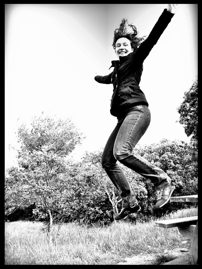 full length, lifestyles, transfer print, leisure activity, casual clothing, young adult, auto post production filter, tree, person, clear sky, standing, field, grass, arms outstretched, young women, sky, outdoors, holding