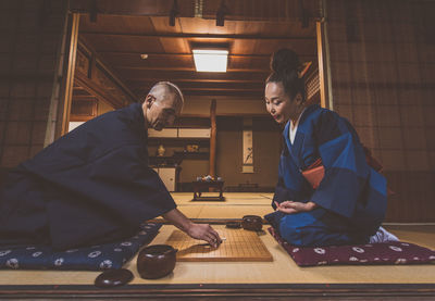 Side view of couple sitting at home