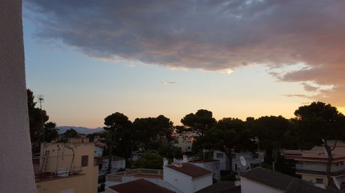 Residential buildings against cloudy sky