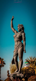 Low angle view of statue against clear blue sky