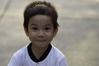 Head shot portrait of 3 years old asian little boy smile and looking at the camera.happy asian kid.