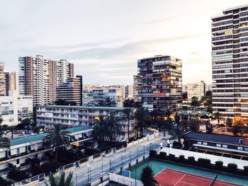 High angle view of street amidst buildings against sky