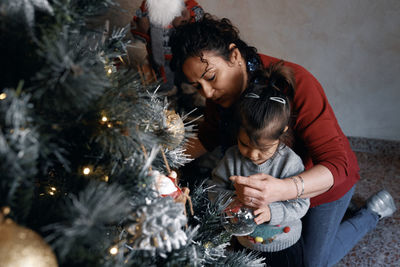 Young woman looking at christmas tree