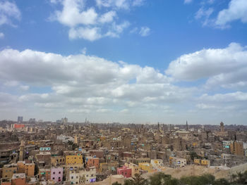 Cityscape against cloudy sky