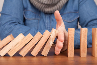 Midsection of woman playing with dominoes on table