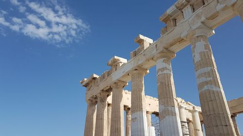 Low angle view of old ruins against blue sky