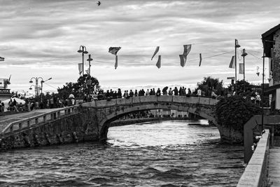 View of bridge over river against cloudy sky