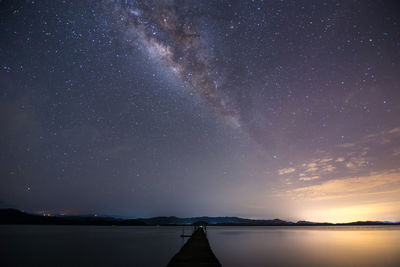 Scenic view of lake against sky at night