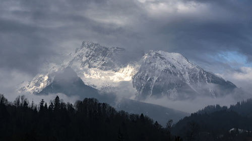 Low angle view of snowcapped mountains against sky