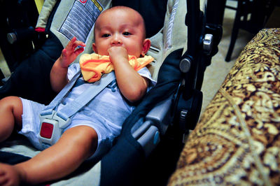 Portrait of cute boy relaxing in stroller