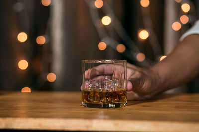 Midsection of person on glass table