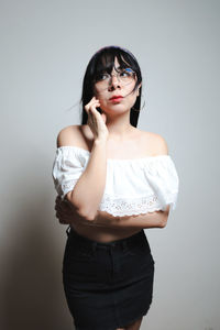 Young woman standing against white background