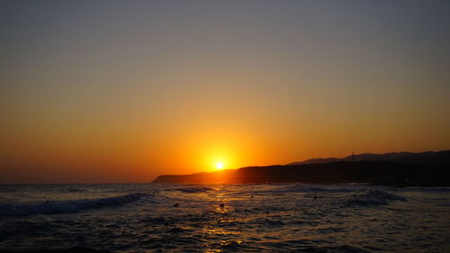 Scenic view of sea against clear sky during sunset