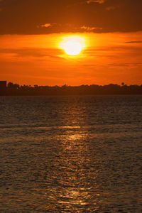 Scenic view of sea against romantic sky at sunset