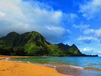 Scenic view of sea and mountains against sky