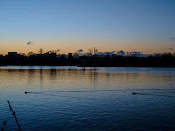 Scenic view of lake against sky during sunset
