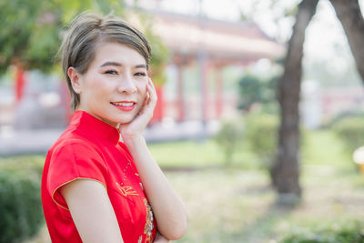 Portrait of smiling woman standing outdoors