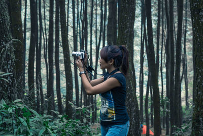 Woman standing in forest