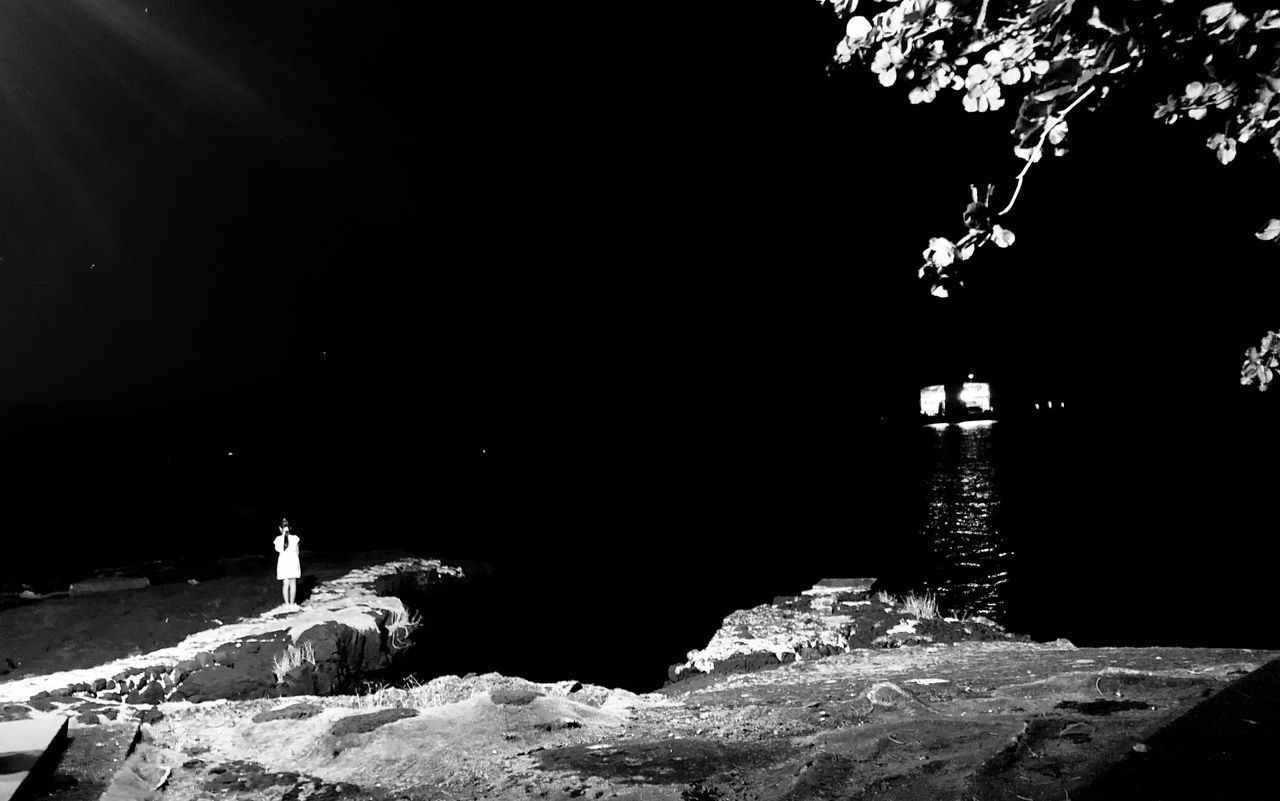 SILHOUETTE PEOPLE STANDING ON ROCK AGAINST SKY