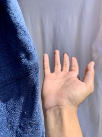 Close-up of hand by towel