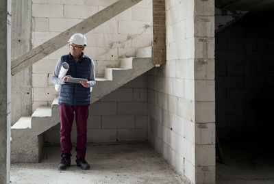 Full length of man standing in abandoned building