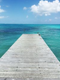 Pier over sea against sky