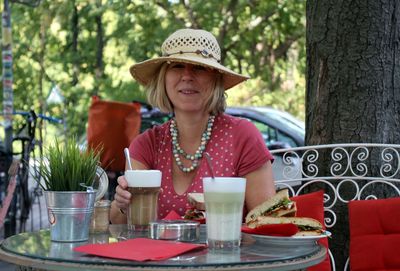 Portrait of woman having cafe macchiato at outdoors table