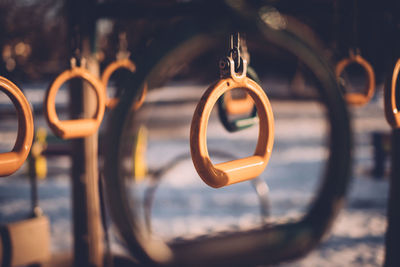 Metallic rings hanging in playground during winter