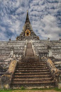 Low angle view of building against cloudy sky