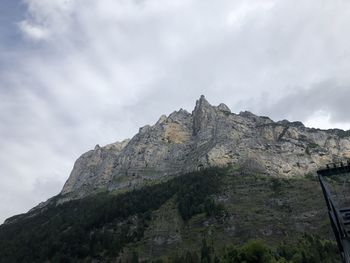 Low angle view of rocky mountain against sky