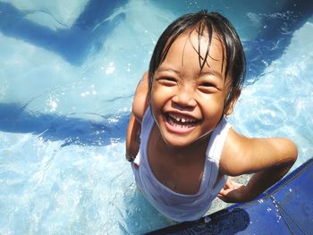 Portrait of laughing girl in swimming pool