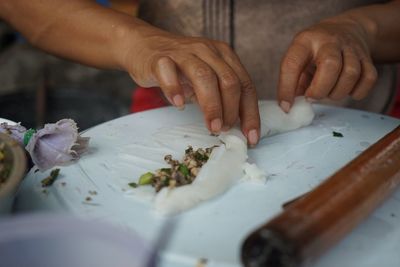 Midsection of woman preparing food