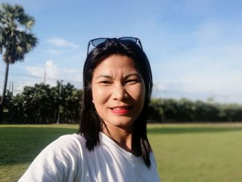 Portrait of beautiful woman against sky