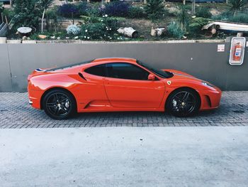 High angle view of red car parked on street