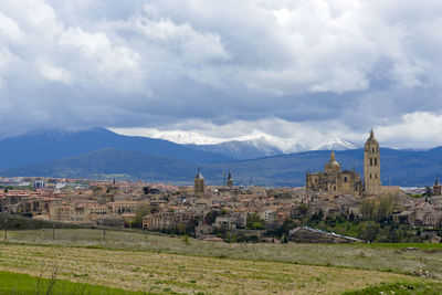 Buildings against cloudy sky