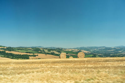 Scenic view of field against blue sky