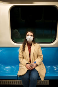 Portrait of young woman in train