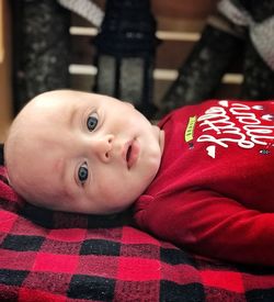 Portrait of cute baby boy lying on bed